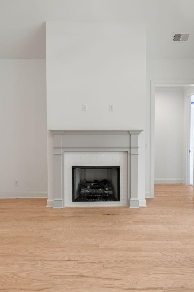 room details featuring a fireplace and wood-type flooring