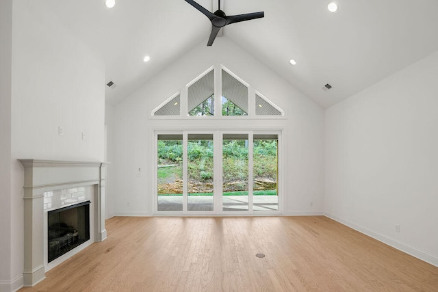 unfurnished living room featuring ceiling fan, high vaulted ceiling, and light hardwood / wood-style floors