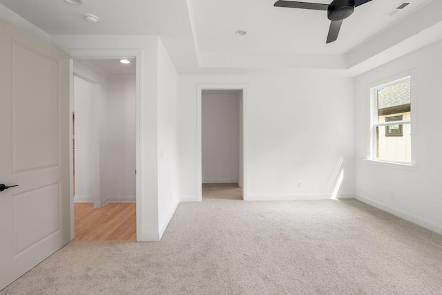 spare room featuring ceiling fan and light colored carpet