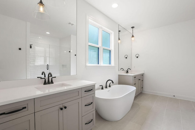 bathroom with plus walk in shower, tile patterned flooring, and vanity