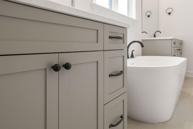 bathroom with tile patterned flooring and a tub to relax in