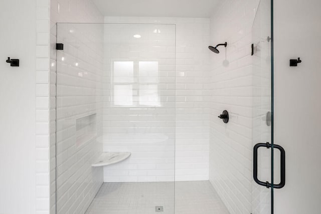 bathroom with a shower with shower door