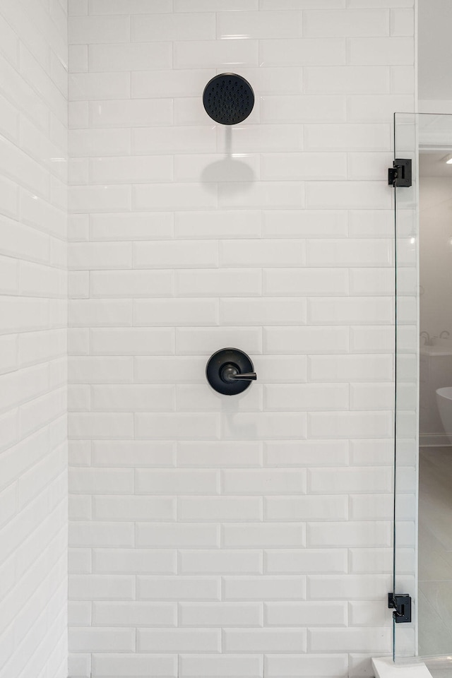 interior details featuring tiled shower