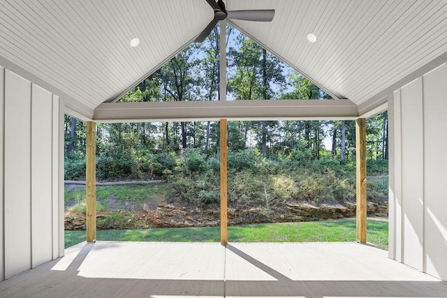 unfurnished sunroom with ceiling fan and vaulted ceiling