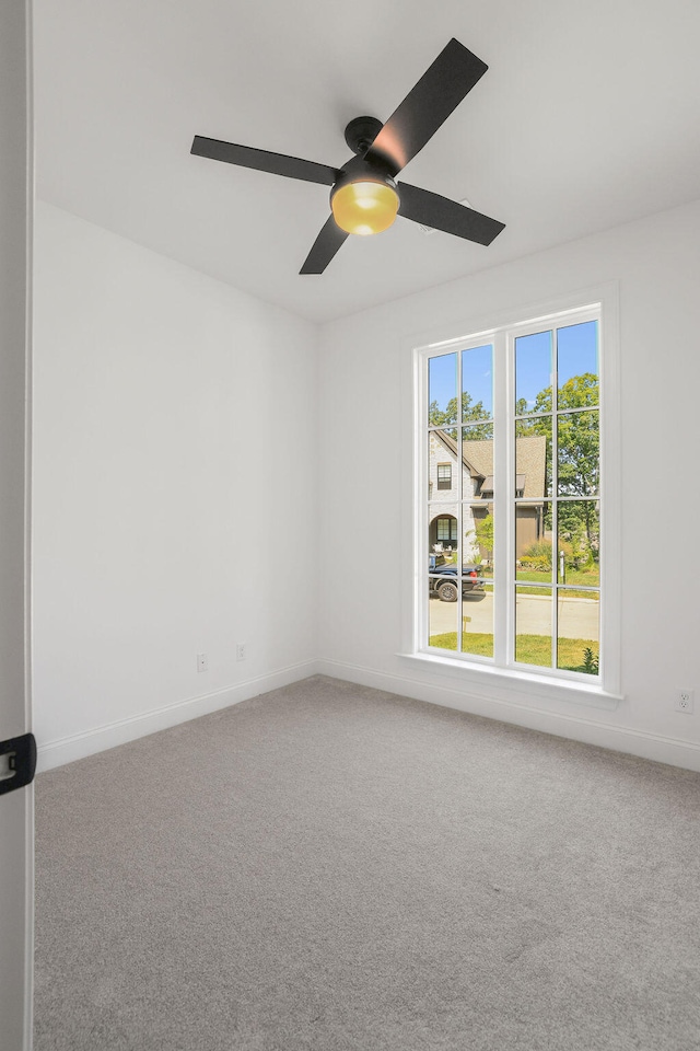 carpeted empty room with ceiling fan