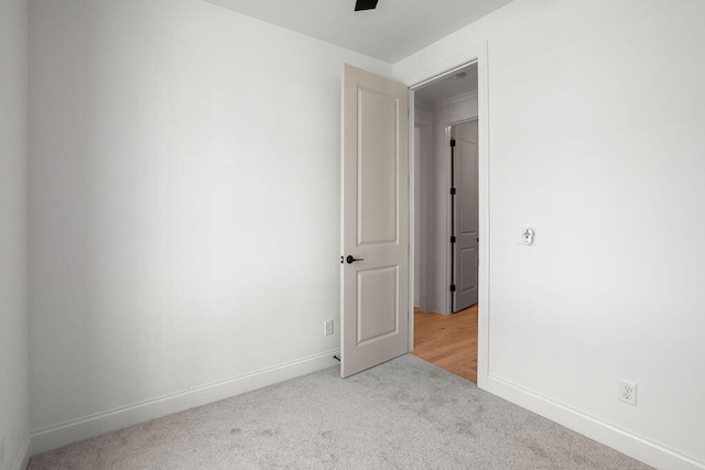 empty room featuring light colored carpet