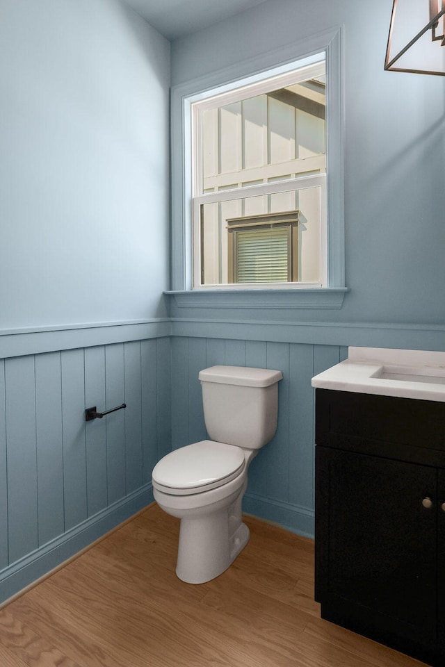 bathroom featuring vanity, hardwood / wood-style flooring, and toilet