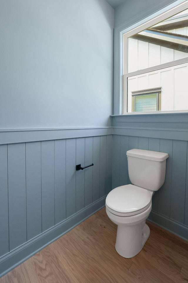 bathroom with hardwood / wood-style flooring and toilet