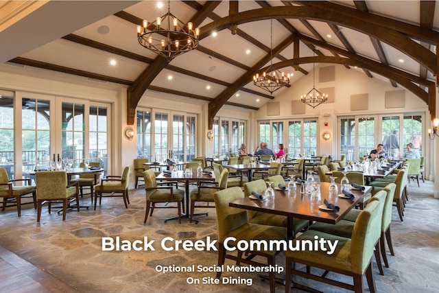 dining area featuring french doors, an inviting chandelier, high vaulted ceiling, and beam ceiling