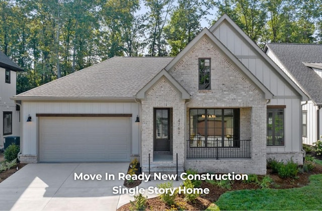 view of front of home with central air condition unit and a garage