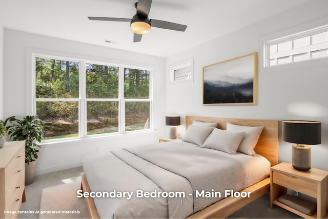 bedroom featuring ceiling fan, light carpet, and multiple windows