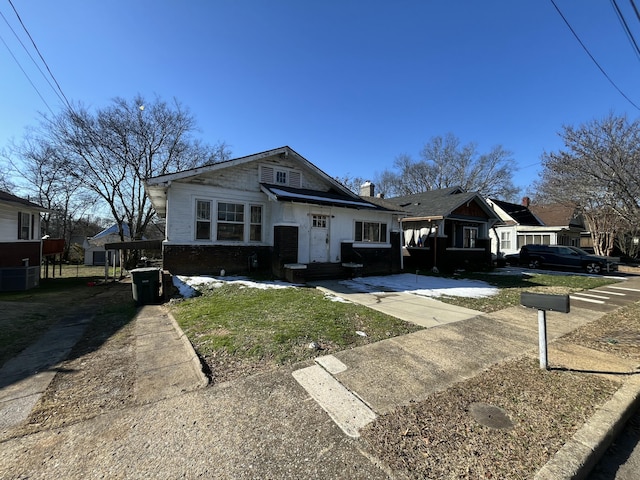 view of front of property featuring cooling unit and a carport