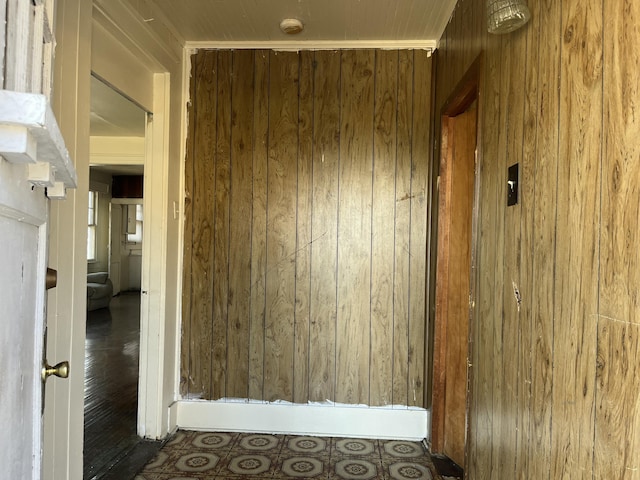 corridor featuring wooden walls