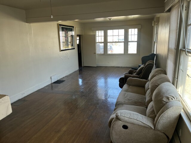 unfurnished living room featuring dark wood-type flooring