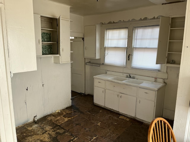 kitchen featuring sink and white cabinets