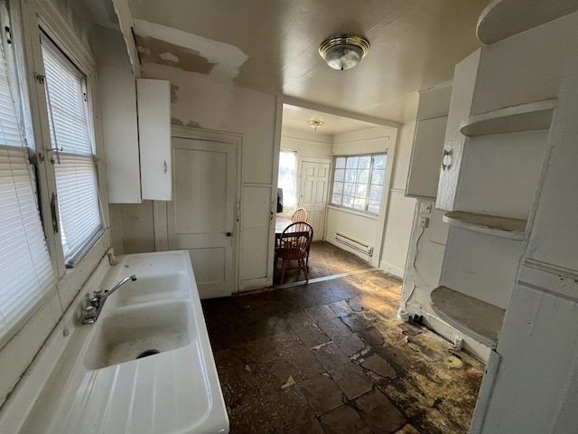 bathroom featuring a baseboard heating unit and sink