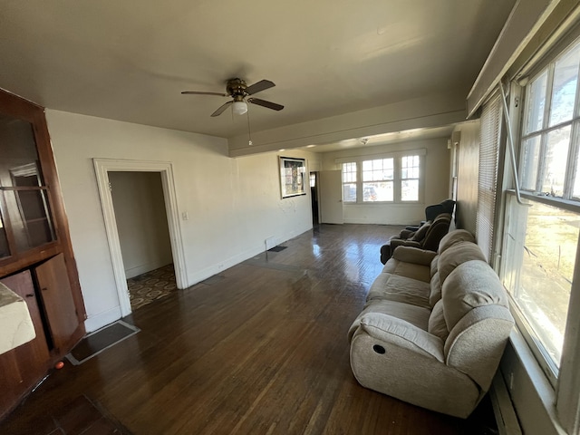 living room featuring ceiling fan and dark hardwood / wood-style floors