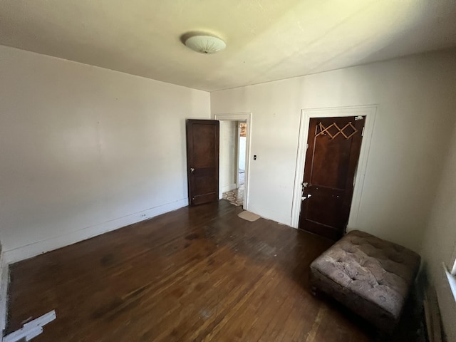 empty room with dark wood-type flooring