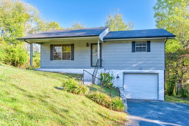 ranch-style house with a garage and a front lawn