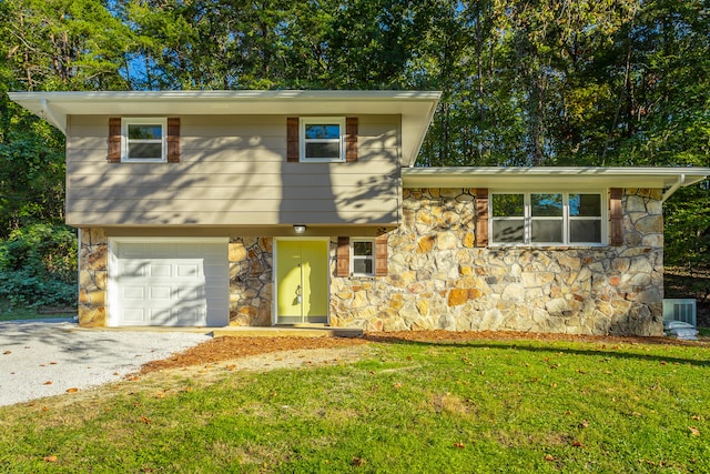 tri-level home with a front lawn and a garage