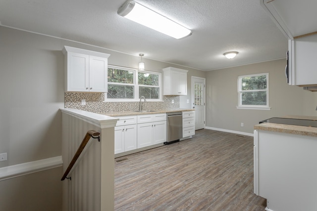 kitchen featuring white cabinets, stove, stainless steel dishwasher, light hardwood / wood-style flooring, and sink