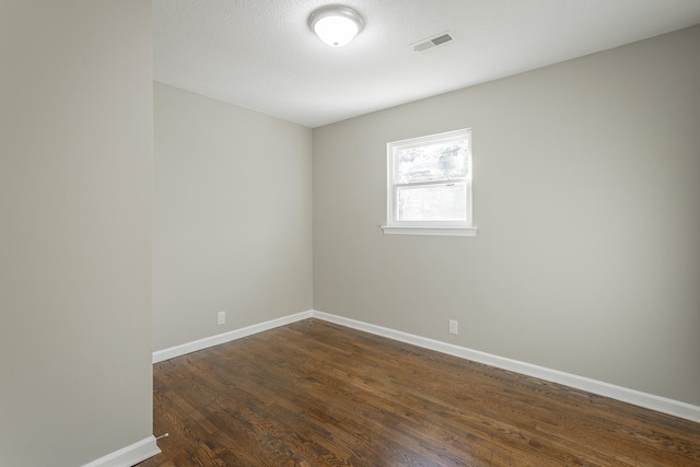 empty room with dark hardwood / wood-style floors