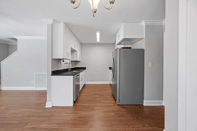 kitchen featuring appliances with stainless steel finishes, sink, and white cabinets