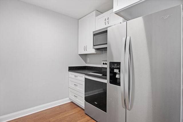 kitchen featuring light hardwood / wood-style floors, stainless steel appliances, and white cabinets