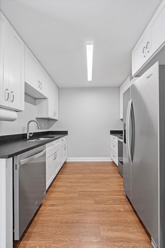 kitchen featuring sink, white cabinetry, light hardwood / wood-style flooring, and stainless steel appliances