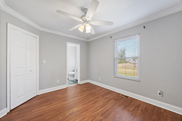 unfurnished bedroom with ornamental molding, hardwood / wood-style flooring, connected bathroom, and ceiling fan