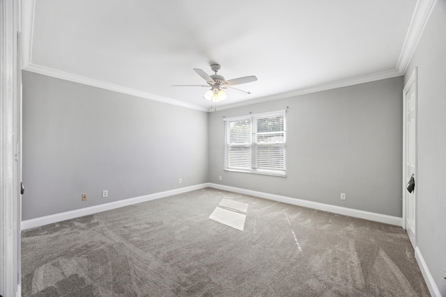 carpeted spare room with ceiling fan and ornamental molding