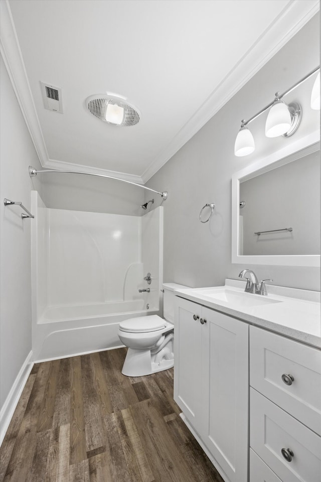 full bathroom with wood-type flooring, bathing tub / shower combination, toilet, vanity, and crown molding