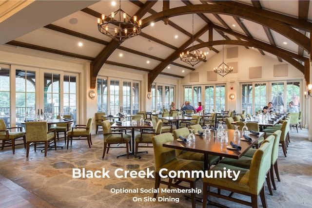 dining space featuring beamed ceiling, a chandelier, high vaulted ceiling, and french doors