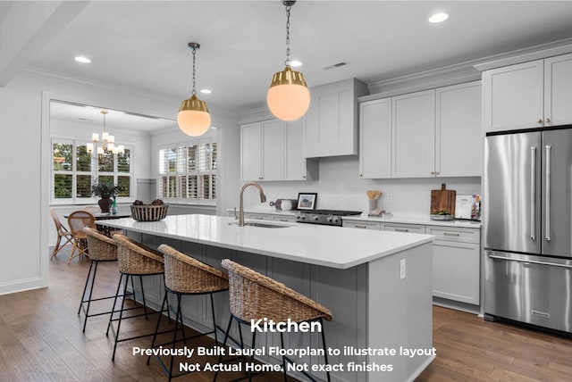 kitchen featuring sink, stainless steel appliances, dark hardwood / wood-style floors, a center island with sink, and white cabinets