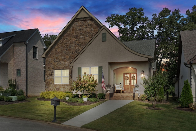 view of front of property with a lawn and central AC unit