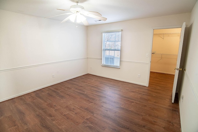 empty room featuring dark hardwood / wood-style floors and ceiling fan