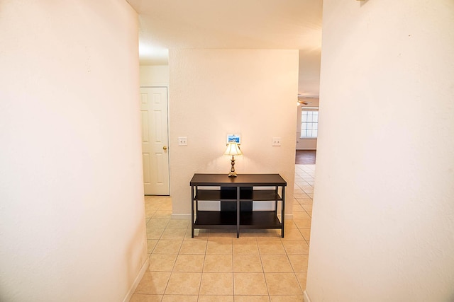 hall with light tile patterned floors