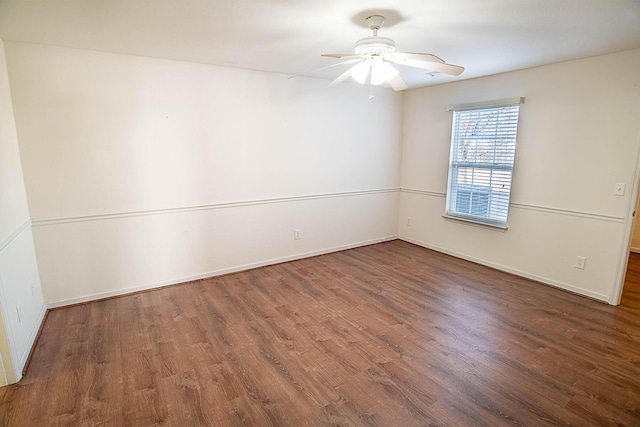 empty room with dark hardwood / wood-style floors and ceiling fan