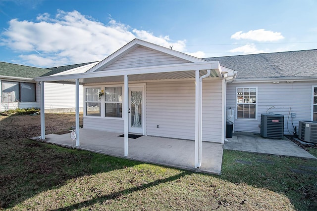 back of property featuring a yard, a patio, and central AC