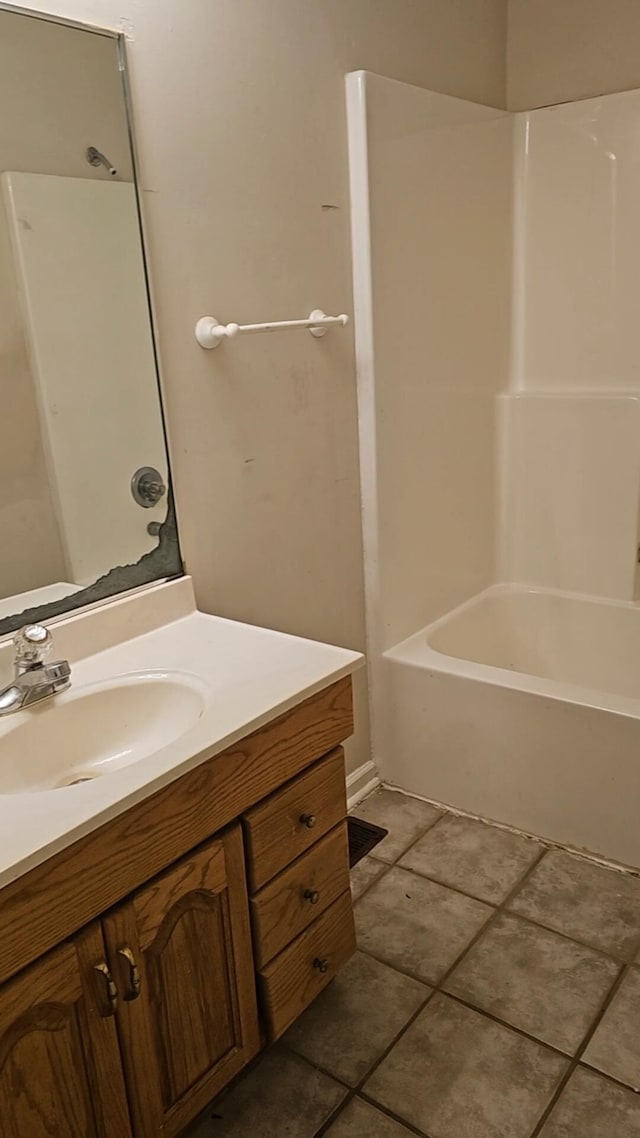 bathroom featuring vanity, tile patterned floors, and tub / shower combination