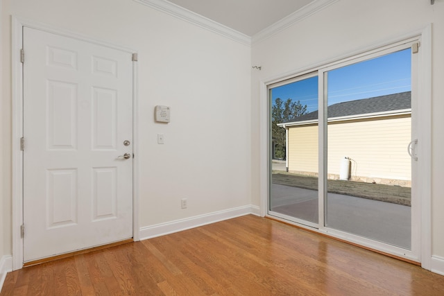 unfurnished room with crown molding and hardwood / wood-style flooring