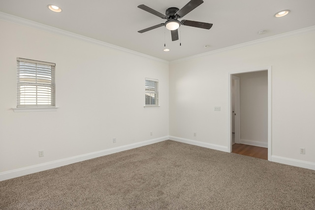 carpeted spare room with ornamental molding and ceiling fan