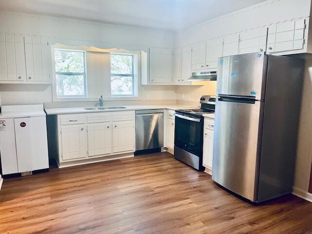 kitchen featuring white cabinetry, hardwood / wood-style flooring, stainless steel appliances, and sink