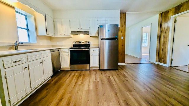 kitchen featuring a wealth of natural light, sink, appliances with stainless steel finishes, and white cabinetry