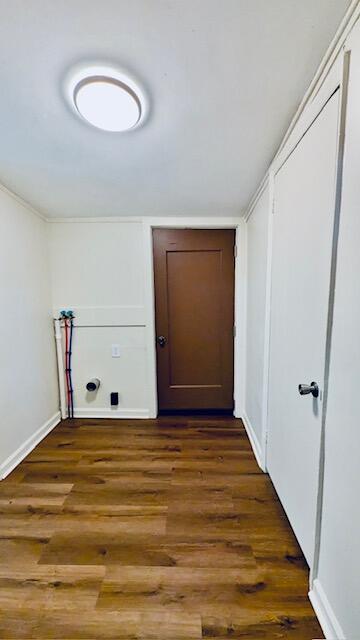 washroom with hookup for a washing machine and dark wood-type flooring