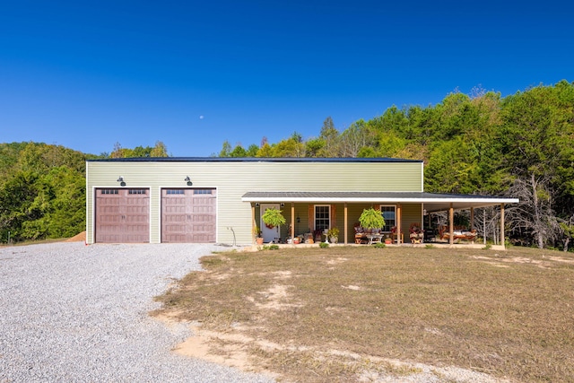 ranch-style home with covered porch and a garage