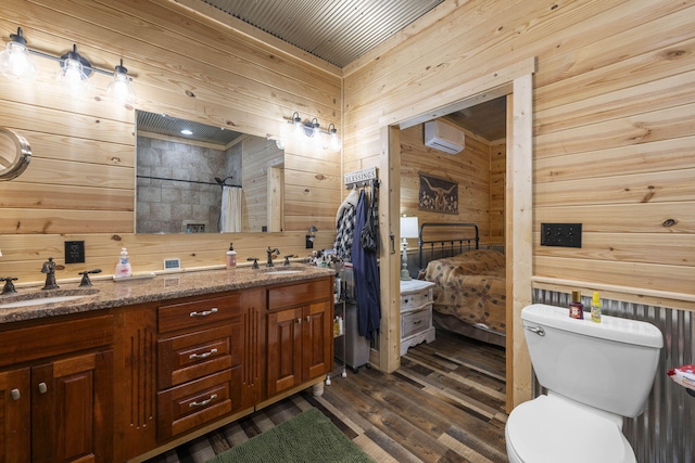 bathroom with toilet, wood walls, and an AC wall unit