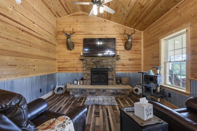 living room with vaulted ceiling, a healthy amount of sunlight, and wood walls