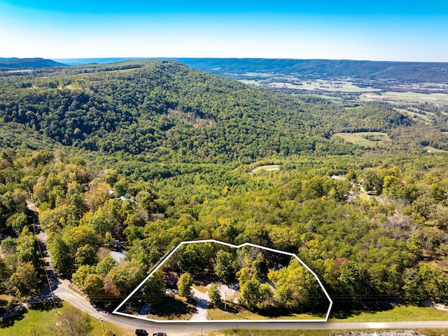 birds eye view of property featuring a view of trees