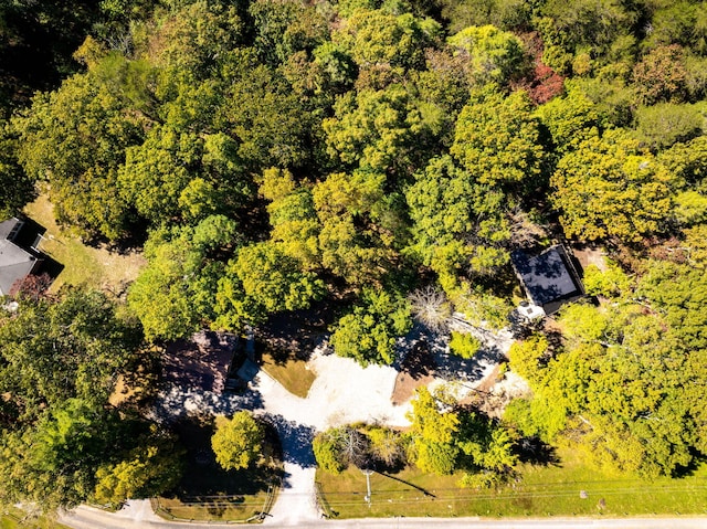 birds eye view of property featuring a view of trees